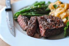 steak and asparagus on a white plate