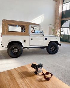 an off - road vehicle is parked in a large room