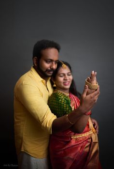 a man and woman are posing for the camera