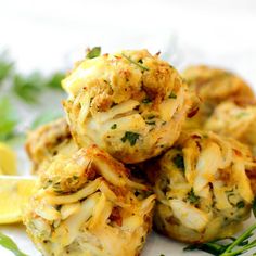 baked crab cakes on a plate with lemon wedges