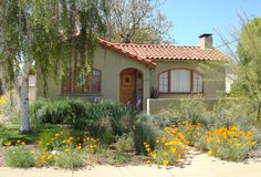 a house with flowers in the front yard