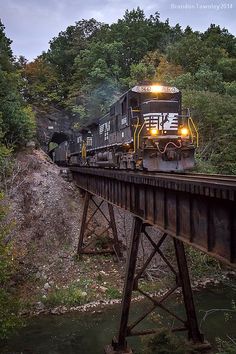 a train traveling across a bridge over a river