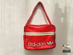 An original vintage Adidas sport bag from the 1980's. An absolute gem for vintage fans. Size:  40 x 30 x15 H x W x D (all dimensions are in cm) Materials: artificial leather, textile, metal condition: The bag is in excellent vintage condition, depending on its age.  The zippers work perfectly. Signs of use. See pictures for details. Shipping: - My shop ships worldwide. - If you like, select the "EXPRESS  shipping" option in the order process to get faster shipping. - You can see the shipping prices in the Shipping menu. Choose your country and your shipping price will appear. - If you order multiple items, the shipping price is automatically calculated as a collective order. So you always get the lowest shipping price. - After the payment the articles are ready for dispatch after 1-2 days. Vintage Red Shoulder Bag For Daily Use, Red Rectangular Sports Bag, Vintage Red Rectangular Shoulder Bag, Vintage Red Bags For Daily Use, Vintage Red Shoulder Bag For Travel, Retro Red Travel Bags, Retro Red School Shoulder Bag, Sporty Red Rectangular Bag, Vintage Red Shoulder Bag