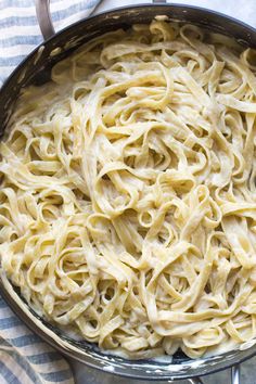 a pan filled with pasta sitting on top of a table