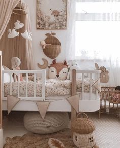 a baby's room is decorated in white and neutrals, with an animal themed crib