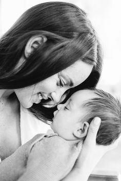 a woman holding a baby in her arms