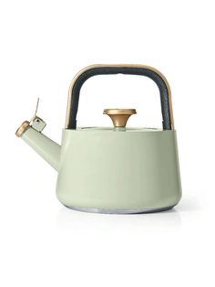 a green tea kettle with a gold top on a white background and a black handle