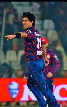 a man in blue and red uniform throwing a ball