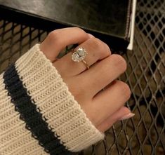 a woman's hand with a ring on it