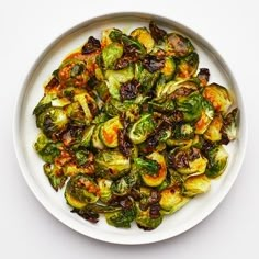 a white bowl filled with brussel sprouts on top of a table