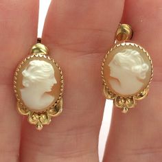 Hand carved genuine shell vintage cameo earrings set in bezel settings have screw backs. These are perfect for non-pierced ears and can be also be easily worn by those with pierced ears. Shiny gold fill oval bezels with saw tooth edging sit atop dainty floral bowers. Earrings are 17 mm long by 11 mm wide ovals with a depth of about 5 mm. Screw backs are signed C.T. and marked 1/20 12K G. F. The carvings are nicely done by hand, the women are similar yet interestingly different from one another. Victorian Cameo Yellow Gold Earrings, Classic Intaglio Earrings For Formal Events, Classic Intaglio Earrings For Formal Occasions, Formal Carved Earrings, Classic Cameo Earrings For Wedding, Victorian Cameo Earrings For Formal Occasions, Classic Cameo Earrings, Classic Cameo Earrings Gift, Gold Cameo Earrings For Collectors