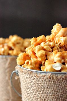 two metal buckets filled with caramel popcorn