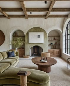 a living room filled with furniture and a fire place in the middle of a room