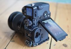 a camera sitting on top of a wooden table