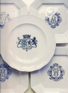 four plates with blue and white designs are stacked on top of each other in rows