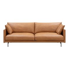 a tan leather couch with two pillows on the back and one arm folded over it