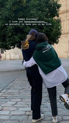 two people hugging each other in front of a tree with the words happy birthday on it