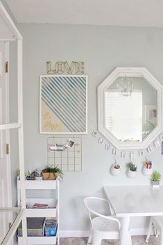 a dining room table with chairs and a mirror on the wall above it that says welcome