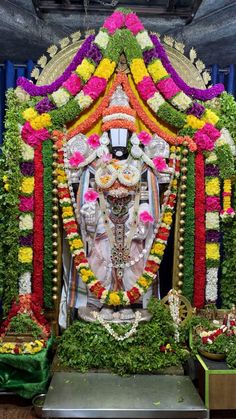 an idol is decorated with flowers and garlands