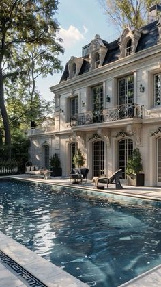 a large house with a pool in front of it