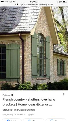 an old brick house with green shutters on the front and side windows in french country - shutters, overhang brackets, home ideas exterior storybook and classic shutters