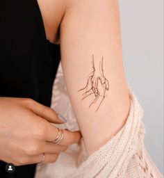 a woman with a small tattoo on her arm