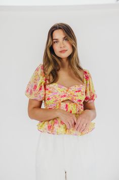 Introducing the Arlet Top in Yellow Multi Floral, a versatile piece that offers premium style with bright pops of color, just in time for spring. This piece pairs beautifully with linen trousers or cut-off denim, and is sure to steal the show no matter where you wear it. FIT: Runs true to size - fitted in the bodice, with cropped silhouette. MATERIAL: Self: 100% Polyester; Lining: 95% Polyester, 5% Elastane. GARMENT DETAILS: Cropped floral top with puffed sleeves and a bandeau-style bodice; feat Chic Multicolor Spring Tops, Chic Multicolor Tops For Spring, Vibrant Tops For Summer Day Out, Vibrant Tops For Spring Day Out, Vibrant Fitted Spring Tops, Vibrant Cotton Tops For Spring, Vibrant Spring Vacation Tops, Vibrant Yellow Tops For Spring, Garment Details