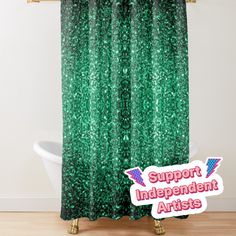 a green shower curtain with the words support independent artists on it in front of a bathtub