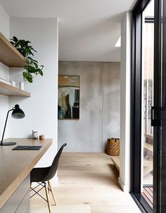 a room that has some shelves on the wall and a desk in front of it