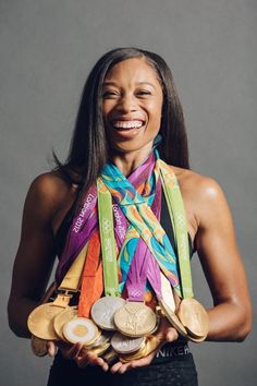 a woman holding two gold, silver and bronze medals with the words olympic strength exercises