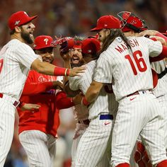 a group of baseball players congratulating each other