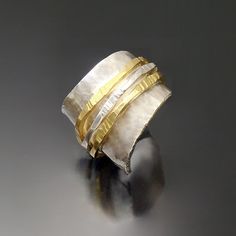 Gold & Silver Ring - A study in texture and contrast, this distinctive, hand-hammered ring pairs the cool shimmer of sterling silver with the warmth of 18k gold. Available in whole and half sizes 6 to 8.5. For pricing and availability of sizes outside of this range, please contact our customer care department.Care instructions. Polish with a silver polishing cloth. Unique Hammered Wide Band Rings, Elegant Sterling Silver Hammered Wide Band Ring, Elegant Hammered Wide Band Ring In Sterling Silver, Modern Hammered Rings For Anniversary, Ring Texture, Hammered Ring, Artful Home, Wide Rings, Customer Care