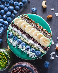 blueberries, bananas and granola arranged on a plate