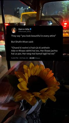 a sunflower in a vase on the dashboard of a car with an instagram message