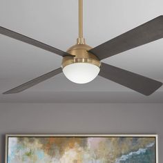 a ceiling fan in a living room with a painting on the wall