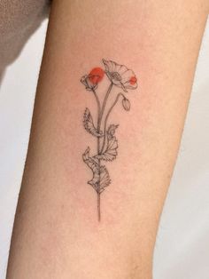 a single flower tattoo on the right arm and leg, with red flowers growing out of it