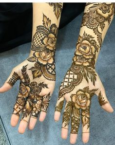 two hands with henna designs on them