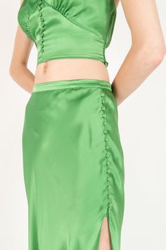 Product Description: The elegance of this maxi skirt is unmatched. This piece is made entirely from 100% Lustrous soft Silk and bias cut shape that drapes gorgeously. Self fabric silk covered buttons with side slit opening. Pair it with the Stacey Top for a matching set look or with any basic tops. Fabric: 100% Silk Color: Kelly Green Size and Fit: Our model is 5'10" and is wearing a size XS. Care Instructions: Cold Hand Wash or Dry Clean Wrap Skirt Pattern, Mother Knows Best, Blouse Tank Top, Fabric Silk, Everyday Dresses, Green Silk, Bag Dress, Basic Tops, Skirt Pattern