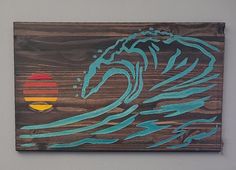 a wooden sign with a painting of a wave on it