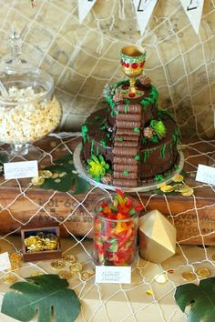 a table topped with a cake covered in lots of toppings next to other items