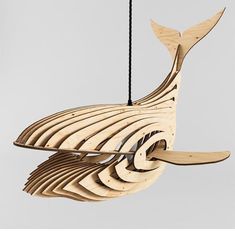 a wooden whale ornament hanging from a string