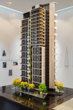 a model of a tall building with plants growing out of it