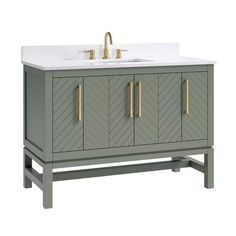 an image of a bathroom vanity with two sinks and gold faucets on it