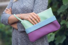 "Lilac clutch bag \"CarryMe\". Clutch purse made of soft vegan leather, fabric inside. Mint shoulder strap comes with clutch so you can wear it like crossbody purse. Unique GoodMoodMoon model.  Size: 9.5\" х 6.5\" (24 x 17 cm.) Shoulder strap length 46\" (118 cm.) If you need another length just let us know :)  Color: mint + lilac Front handle color to choose: lilac, tan, light blue.  Front handle is easily changed on snaps - you can purchase additional handles of colors you like and change them according to your style and mood :)  More handle colors https://www.etsy.com/listing/181832857/front-handle-for-clutch-carryme See full \"CarryMe\" clutch collection https://www.etsy.com/shop/GoodMoodMoon/items?ref=seller-platform-mcnav&section_id=15138083" Boho Clutch Bag, Bridesmaid Purses, Purple Clutch, Orange Handbag, Boho Clutch, Purple Purse, Leather Clutch Purse, Small Crossbody Purse, Boho Purses