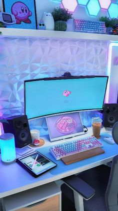 a desk with a computer and speakers on it