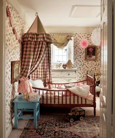 a child's bedroom decorated in pink, green and white checkered wallpaper