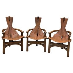 three wooden chairs sitting next to each other