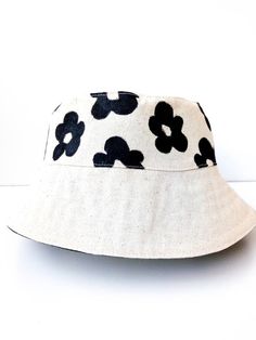 Flower Bucket Hat, White Bucket Hat, Handmade, Handpainted Fashionable and comfortable bucket hat head accessory. Perfect for covering the face and eyes from sun All hats are painted by hand so there might be some ever-so-slight differences (maybe a thicker/thinner brush stroke in some spots) No screen printing or vinyl transfers, it's all made from the heart baby :) Each of these handmade hats is personally sewn and handpainted.  You can also combine your bucket hat with a trendy bag to create Adjustable Bucket Sun Hat For Spring, Spring Adjustable Bucket Sun Hat, Cream Adjustable Bucket Hat, Adjustable Natural Bucket Hat, Adjustable Natural Color Bucket Hat, Spring Bucket Sun Hat, Handmade Bucket Hat For Summer, White Summer Bucket Hat For Festivals, White Handmade Adjustable Bucket Hat