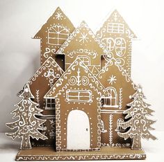 a gingerbread house with trees and snowflakes on it