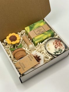 Cozy gift box with sunflower crochet - the perfect way to cheer up a friend and show them just how much you care! Crafted with love and designed to spread positivity, our gift boxes are made to bring joy and warmth to all, wrapped in a beautiful bow. SUNFLOWER GIFT BOX This box includes a handmade soap with a scent of your choice, a natural vanilla lip balm, a wax sachet with a fresh pine forest scent, soy wax candle with a fresh pine forest scent and a crochet sunflower in a pot. A custom gift Sending Love And Hugs, Sunshine Box, Spa Kits, Sending Sunshine, Love And Hugs, Vanilla Lip Balm, Hygge Gifts, Box Of Sunshine, Custom Gift Cards